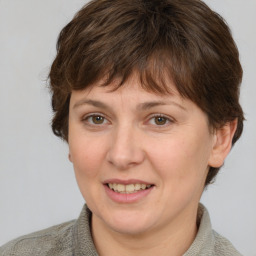 Joyful white young-adult female with short  brown hair and grey eyes