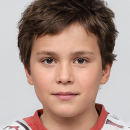 Joyful white child male with short  brown hair and brown eyes