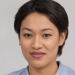 Joyful asian young-adult female with medium  brown hair and brown eyes