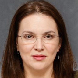 Joyful white adult female with long  brown hair and brown eyes