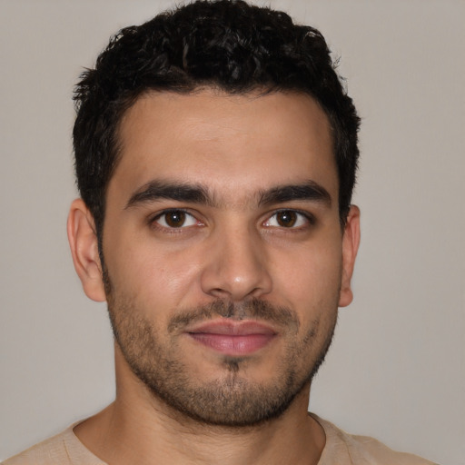 Joyful latino young-adult male with short  brown hair and brown eyes