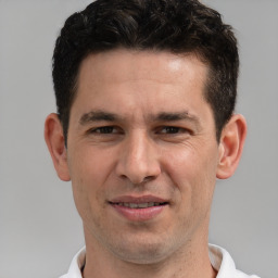 Joyful white adult male with short  brown hair and brown eyes