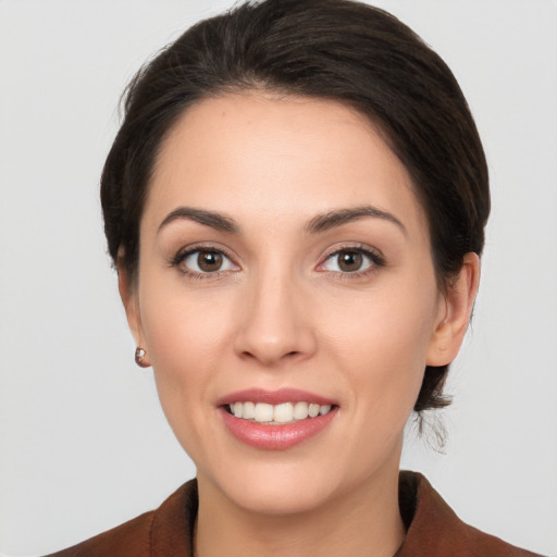 Joyful white young-adult female with medium  brown hair and brown eyes