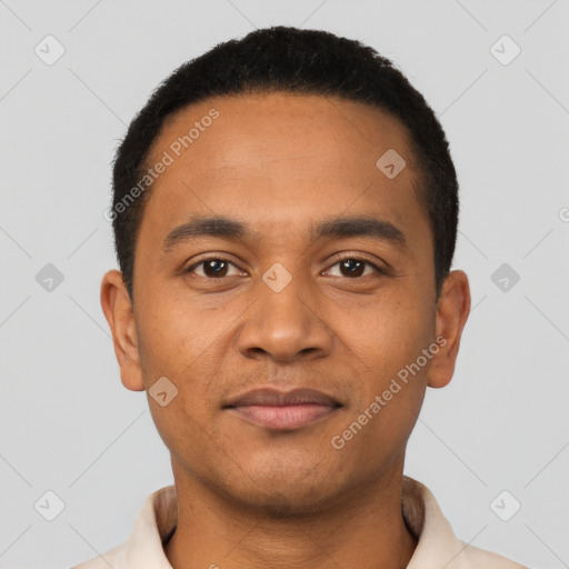 Joyful latino young-adult male with short  black hair and brown eyes