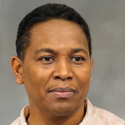 Joyful latino adult male with short  brown hair and brown eyes