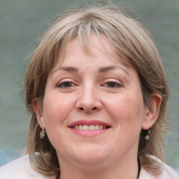 Joyful white adult female with medium  brown hair and grey eyes