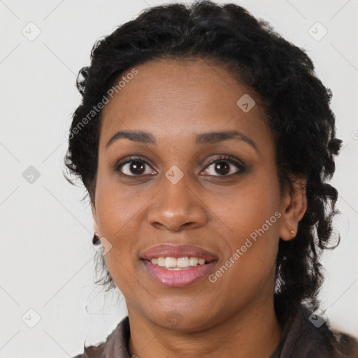 Joyful black young-adult female with long  brown hair and brown eyes