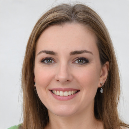 Joyful white young-adult female with long  brown hair and green eyes