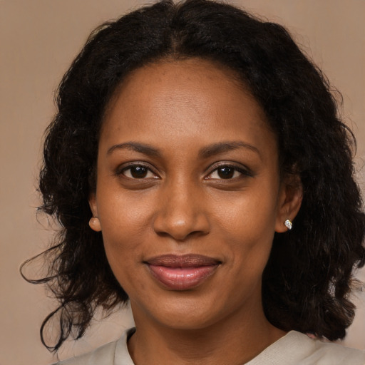 Joyful black young-adult female with medium  brown hair and brown eyes