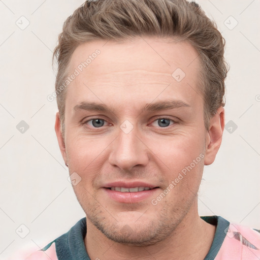 Joyful white young-adult male with short  brown hair and grey eyes