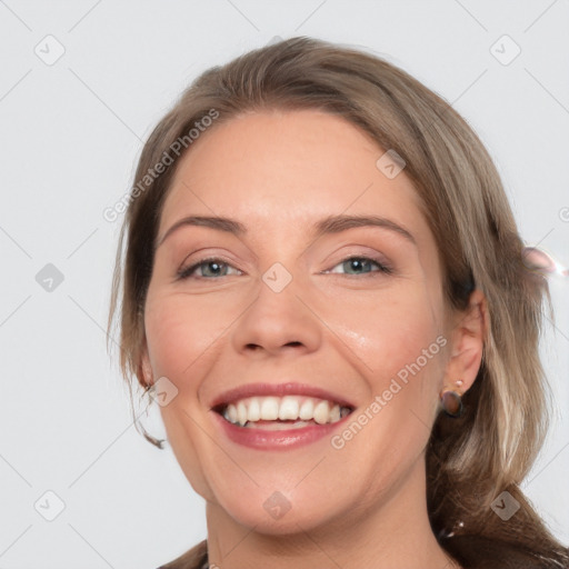 Joyful white young-adult female with medium  brown hair and grey eyes