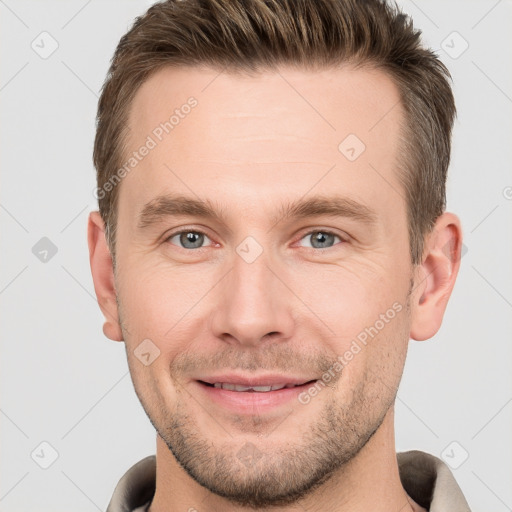 Joyful white young-adult male with short  brown hair and grey eyes