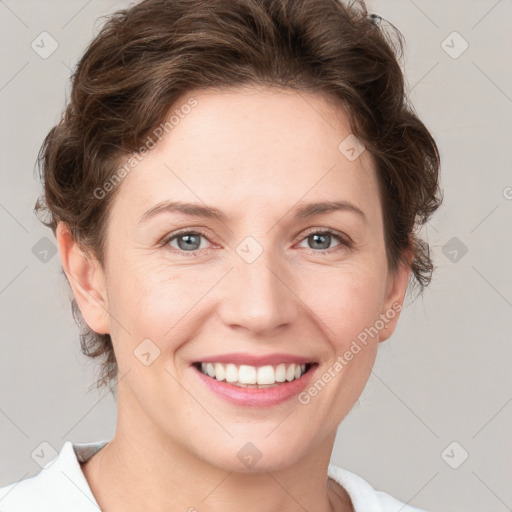 Joyful white young-adult female with short  brown hair and grey eyes