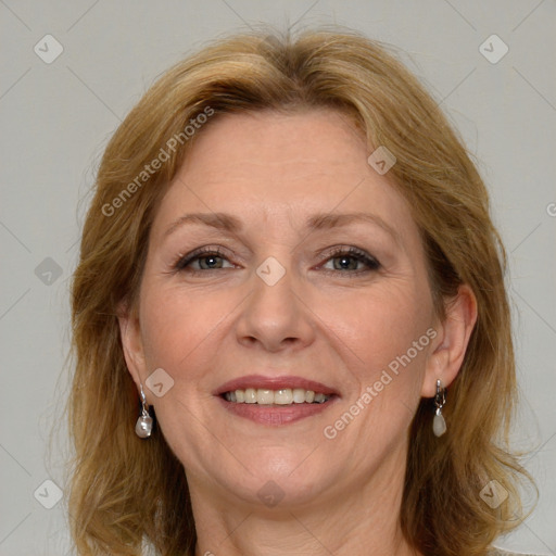 Joyful white adult female with medium  brown hair and blue eyes