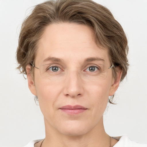 Joyful white adult female with medium  brown hair and grey eyes