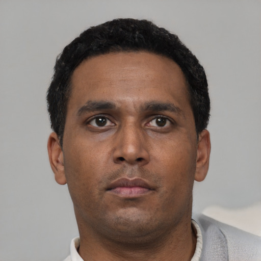 Neutral black young-adult male with short  black hair and brown eyes