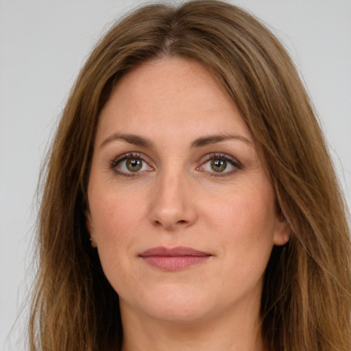 Joyful white young-adult female with long  brown hair and green eyes