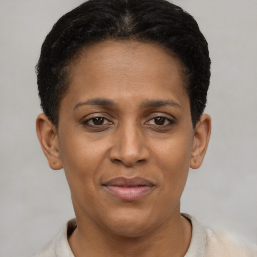 Joyful black young-adult female with short  brown hair and brown eyes