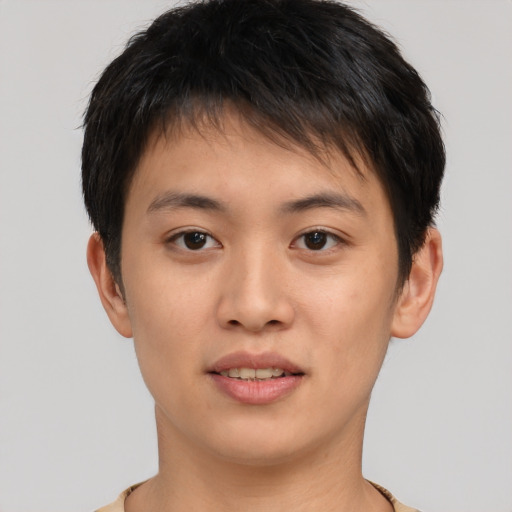 Joyful asian young-adult male with short  brown hair and brown eyes