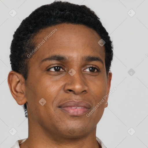 Joyful black young-adult male with short  brown hair and brown eyes