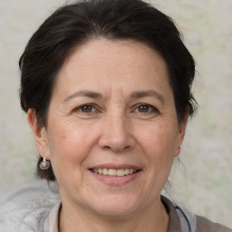 Joyful white adult female with medium  brown hair and brown eyes