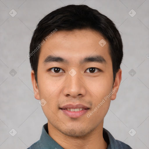 Joyful asian young-adult male with short  black hair and brown eyes