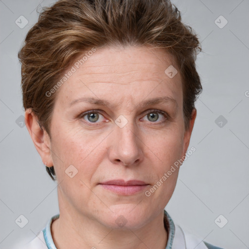 Joyful white adult female with short  brown hair and grey eyes