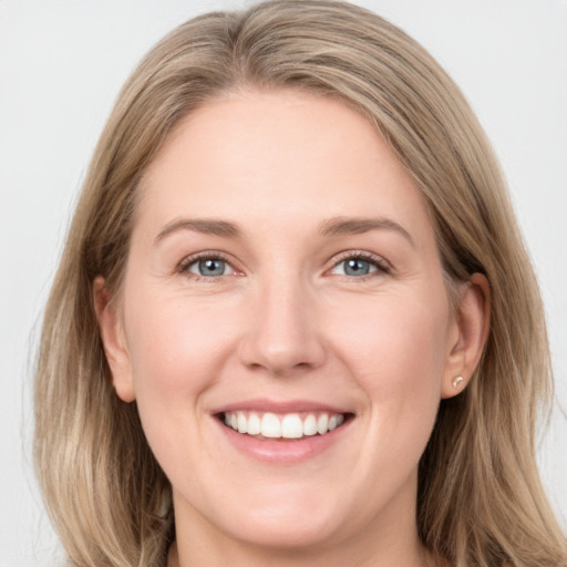 Joyful white young-adult female with long  brown hair and blue eyes