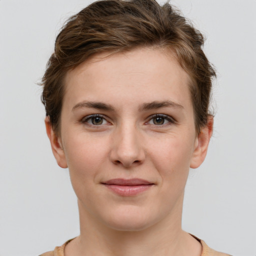 Joyful white young-adult female with short  brown hair and grey eyes