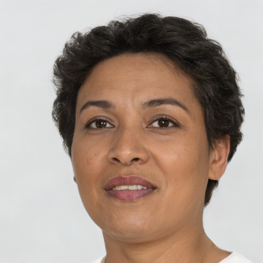 Joyful latino adult female with short  brown hair and brown eyes