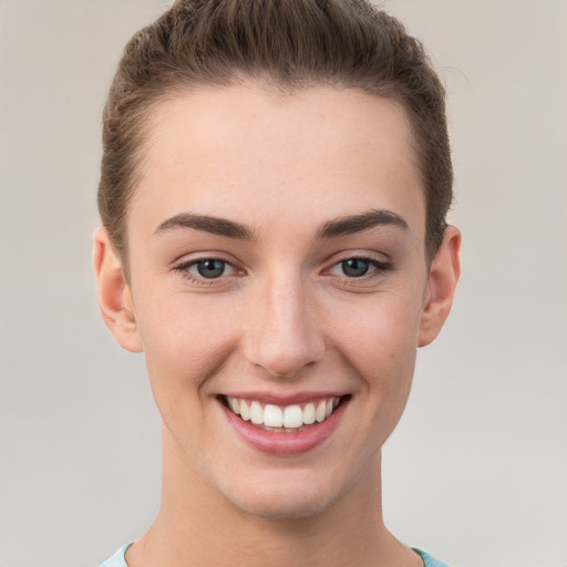 Joyful white young-adult female with short  brown hair and grey eyes