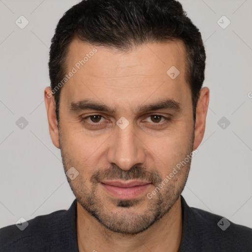 Joyful white adult male with short  brown hair and brown eyes