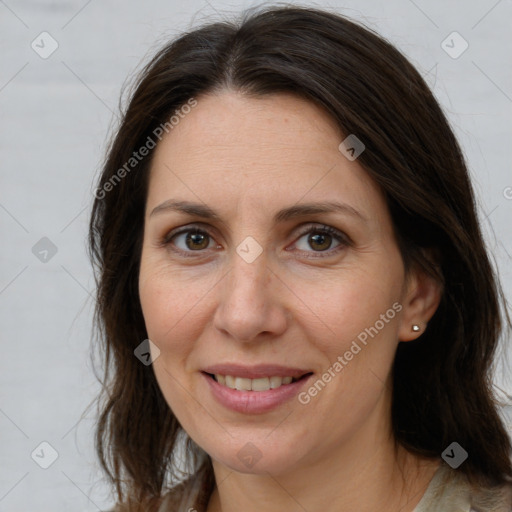 Joyful white adult female with long  brown hair and brown eyes