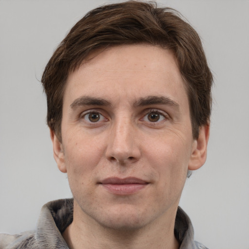 Joyful white adult male with short  brown hair and grey eyes