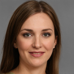 Joyful white young-adult female with medium  brown hair and green eyes