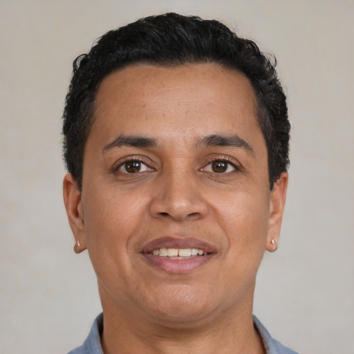 Joyful latino adult male with short  brown hair and brown eyes