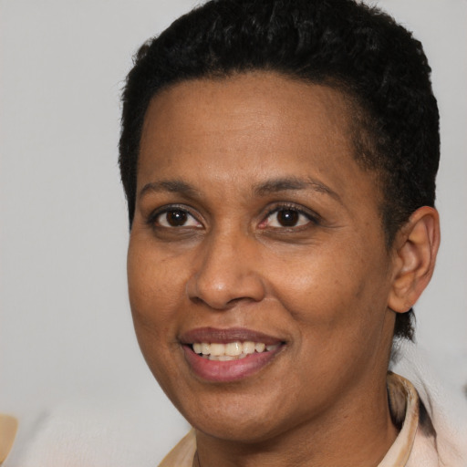 Joyful black adult female with short  brown hair and brown eyes