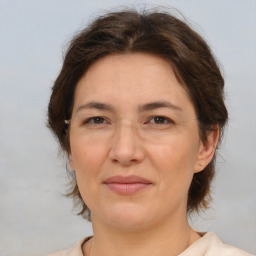 Joyful white adult female with medium  brown hair and brown eyes