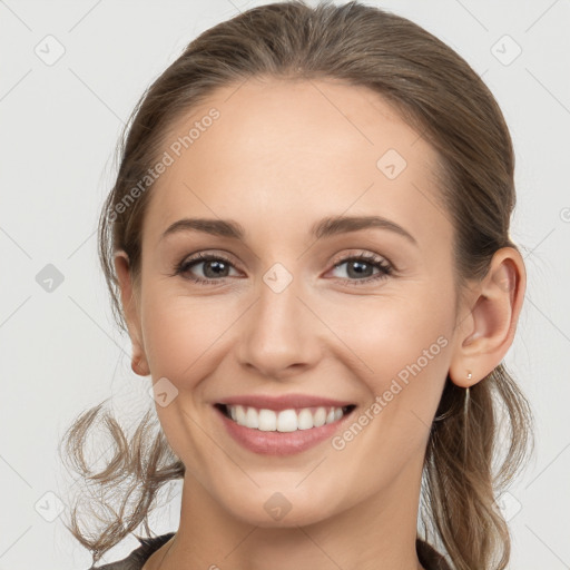 Joyful white young-adult female with medium  brown hair and grey eyes