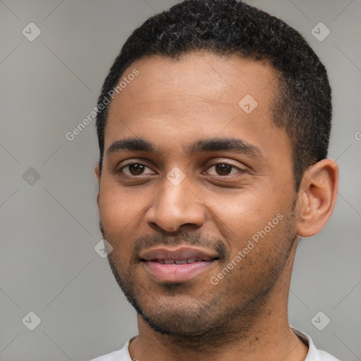 Joyful black young-adult male with short  black hair and brown eyes