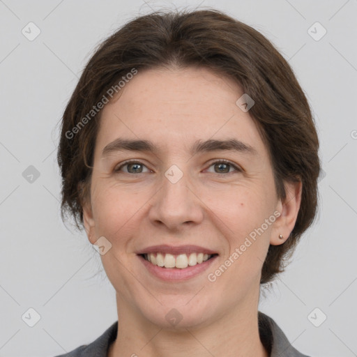 Joyful white adult female with medium  brown hair and grey eyes