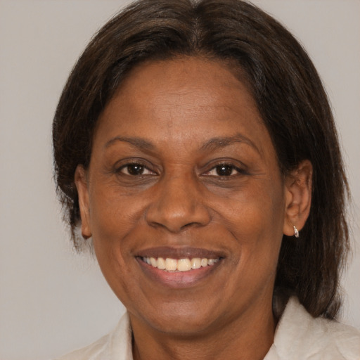 Joyful black adult female with medium  brown hair and brown eyes