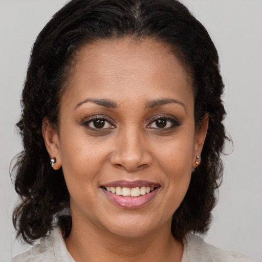 Joyful black young-adult female with medium  brown hair and brown eyes