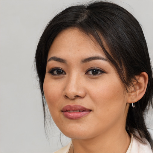 Joyful asian young-adult female with medium  brown hair and brown eyes