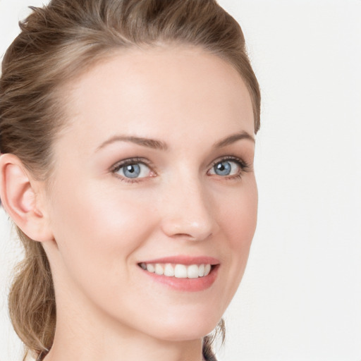 Joyful white young-adult female with medium  brown hair and blue eyes