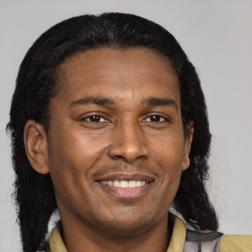Joyful black young-adult male with short  black hair and brown eyes