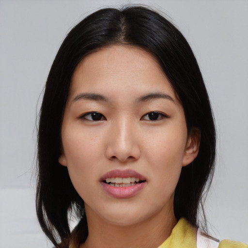 Joyful asian young-adult female with medium  black hair and brown eyes