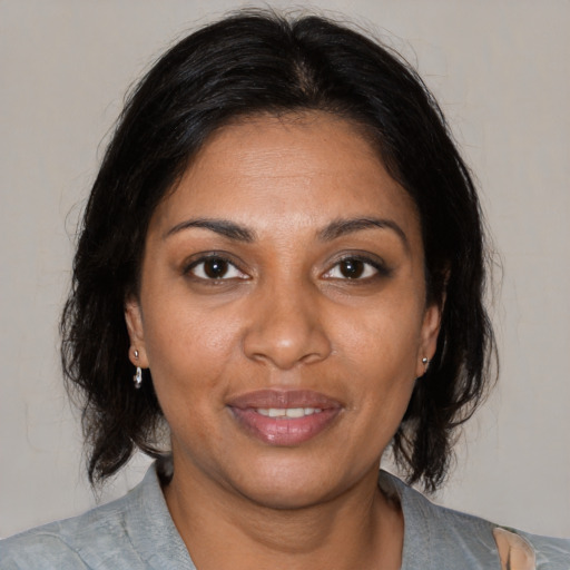 Joyful black young-adult female with medium  brown hair and brown eyes