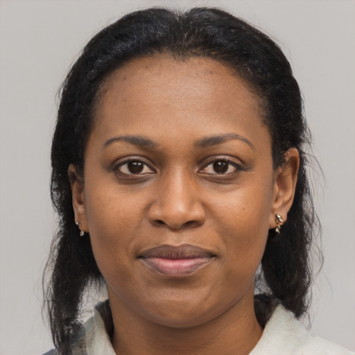 Joyful black adult female with medium  black hair and brown eyes