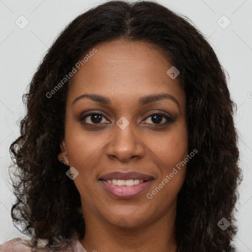 Joyful black young-adult female with long  brown hair and brown eyes